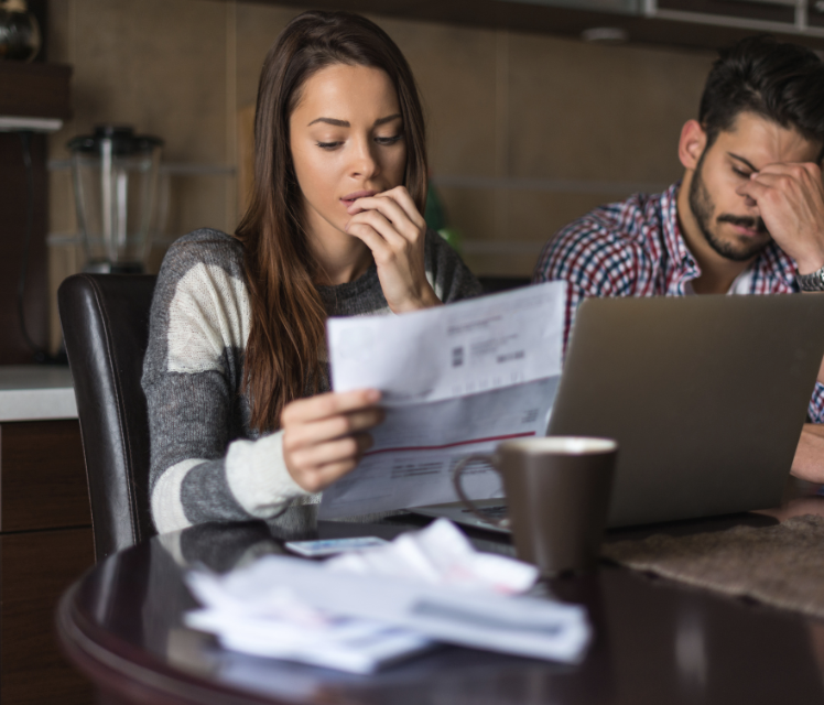 Worker reviewing paycheck for wage theft issues and missing wages.