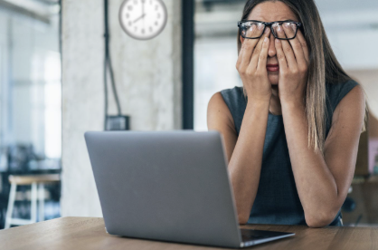 Worker calculating hours on a pay stub, highlighting potential unpaid overtime claims and wage violations.